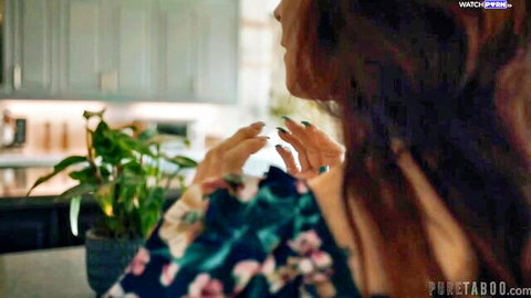 Syren De Mer in floral dress, teasing pose in kitchen, mature redhead beauty