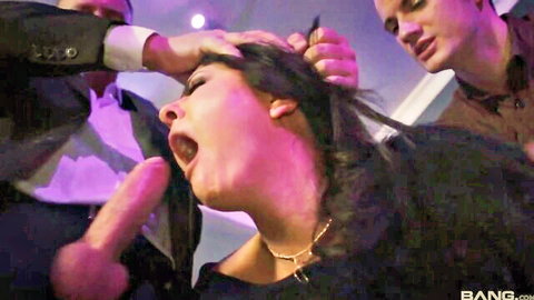Brunette in black dress gives blowjob to two men in hot threesome anal scene