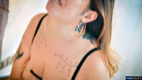 Tattooed redhead babe moaning with massive tits spilling from black bra