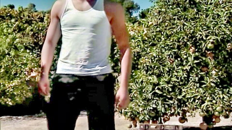 Silvia Saint outdoor anal scene: muscular man in white tank top in orange orchard