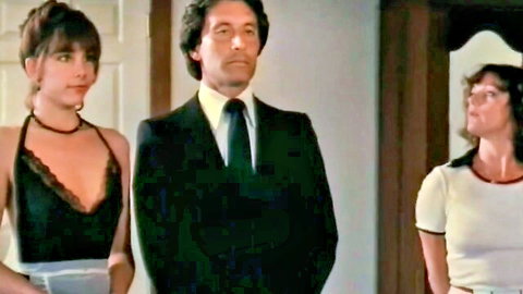 Vintage threesome scene with Kay Parker in black lace and Honey Wilder in white top