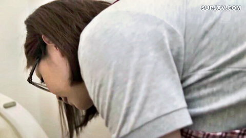Japanese brunette in glasses bends over toilet in gray t-shirt showing average ass
