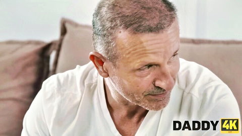 Mature man in white tee gazes intently - Olivia Sparkle Daddy4K scene