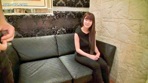 Pretty Asian woman in black dress smiling for POV camera