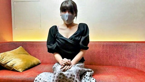 Japanese wife in black off-shoulder top and skirt, masked and seated seductively