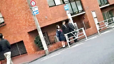 Japanese schoolgirl in uniform chats with suited man on urban street, JAV public tease