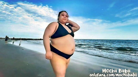 Thick Asian BBW posing in tight black bikini on beach flaunting huge belly thick thighs and ass