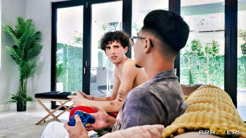 Two shirtless muscular guys gaming, discovering Taylor in living room