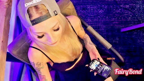 Blonde tattooed FairyBond teasing in crop top, seductive selfie vibe