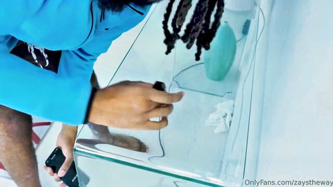 Zay from OnlyFans holding toy and phone in blue outfit tease
