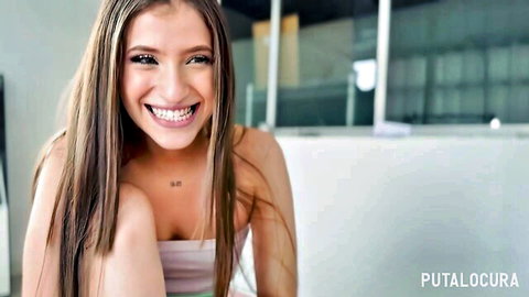 Smiling long-haired brunette teen in pink tube top teasing on camera