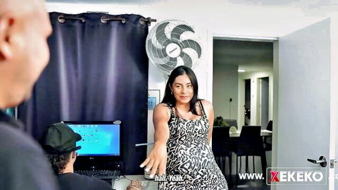 Curvy Latina MILF in tight zebra dress with big tits reaches out to tease bald guy at computer