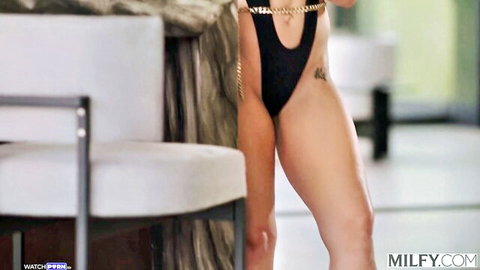 Aderes Quin in sexy black bodysuit with chain, teasing pose as married MILF