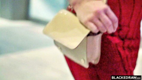 Blonde bombshell Mia Melano in sexy red dress holding beige clutch purse