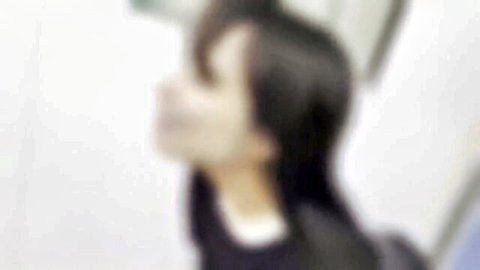 Blurry Asian woman in dark uniform with white collar, handjob service pose