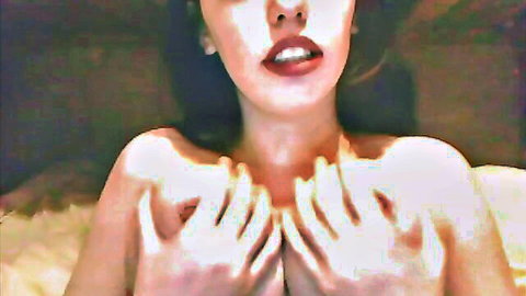 Ashleigh Coffin teases with hands over large breasts in striptease
