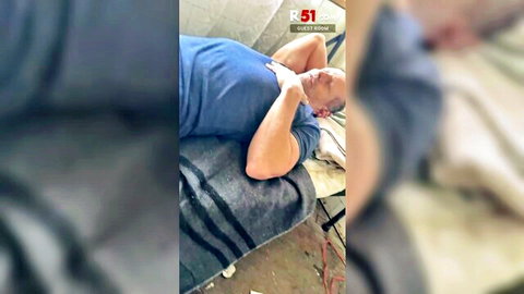 Relaxed middle-aged man in blue t-shirt lying on bed, R51 Day 3 Extreme Shower