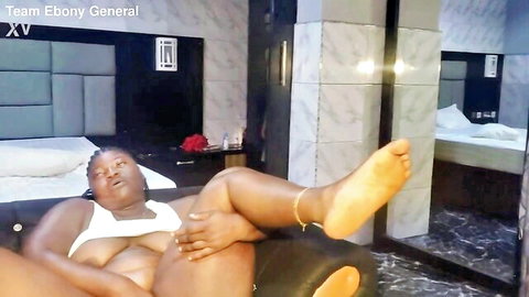 Curvy ebony BBW posing seductively with legs up in white top