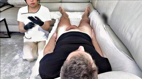 Thai masseuse in gloves performs medical full service massage on exposed man