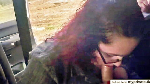 Redhead MILF with glasses sucking stranger's big cock in vehicle outdoors