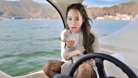 Sexy East Asian girl sticks tongue out teasingly in boat wearing polka dot stockings