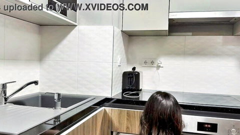 Petite brunette flashing naked ass through transparent black pantyhose in kitchen