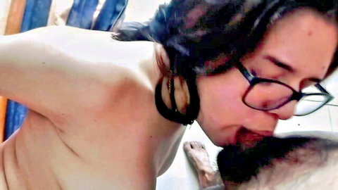 Topless Latina with glasses passionately tongue-kisses bearded man's face up close