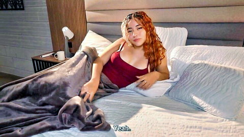 Angel Cruz's seductive stepsister lounging in red top on bed, Colombian beauty