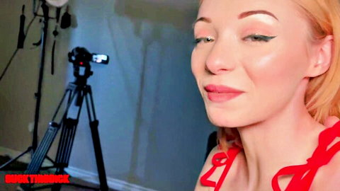 Sultry blonde woman in red top smiling teasingly for blowjob compilation