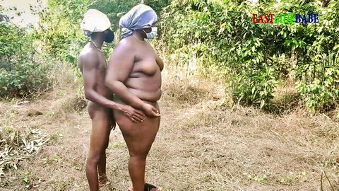 Curvy ebony woman and man nude outdoors in intimate standing pose