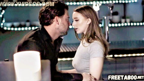 Skinny brunette with small tits passionately kissing handsome boss in neon bar.