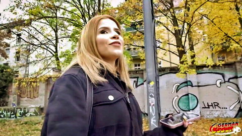 Sexy blonde in tight jeans smirks on graffiti urban street teasing for pickup fuck
