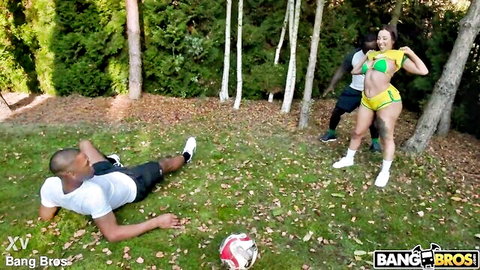 Big ass Latina in yellow thong bikini bends over teasing black guy lying on grass outdoors