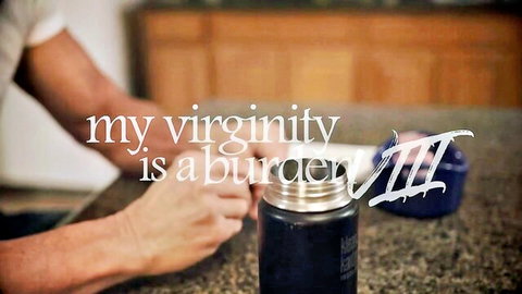 Tan male hands gripping black thermos mug on kitchen counter with 'My virginity is a murderer III' text overlay