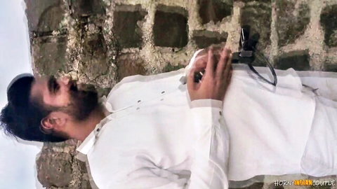 Indian man in white kurta lying outdoors on stone wall, hot couple blowjob and sex thumbnail