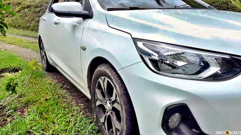 White hatchback car on dirt road in rural greenery, stepsister cheating video thumbnail