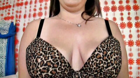Roxy Foxxx BBW in leopard print bra showing deep cleavage