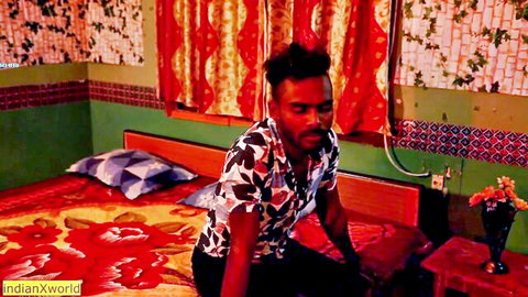 Indian man in floral shirt sits on bed in village room, preview for wife sex video