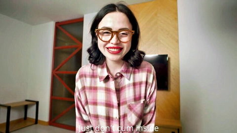 Smiling Asian woman in glasses and plaid shirt says don't cum inside, stepsister creampie tease