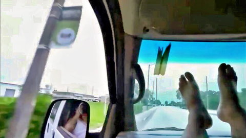 Peter Green in car with cute bare feet propped on dashboard