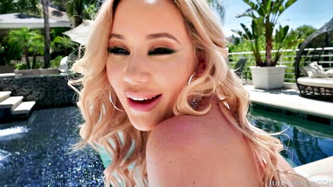 Smiling curvy blonde with huge bare tits posing topless by the pool