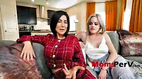 Seductive brunette MILF in red blazer gropes young blonde's thigh on couch