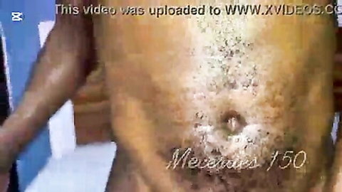 Tattooed cum on brown-skinned man's abs after cougar stepmom fuck