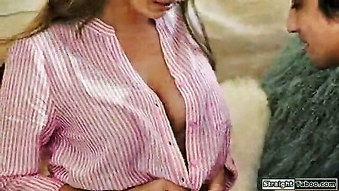 Busty brunette MILF in open striped shirt flashing massive cleavage to bearded man