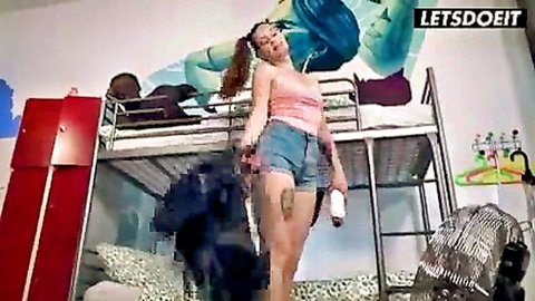 Elena Vega in pink crop top and denim shorts, teasing with BBC guy in hostel