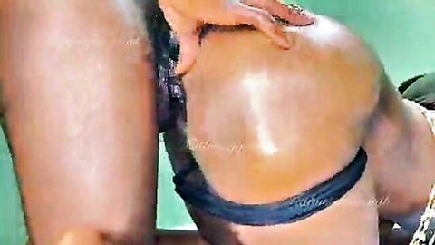 Curvy Asian woman in black lingerie, bent over in doggy style on bed edge
