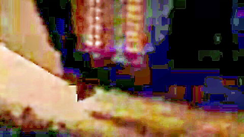 Blurry closeup of colorful hanging fabrics draping over curvy light-skinned body teasing erotically