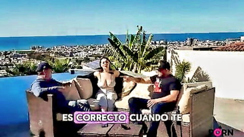 Busty Latina laughs with two men in revealing top during Tijuana nightlife chat