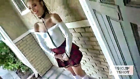 Petite Emily Willis in plaid skirt and stockings, smiling outdoors