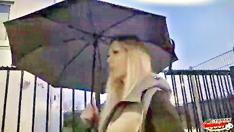 Blonde German model Marie Cherie with umbrella in Berlin street casting